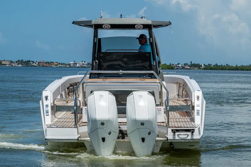 Slide: The Image of 2023 Schaefer V33 boat with dual engines cruising on a calm lake. - 38