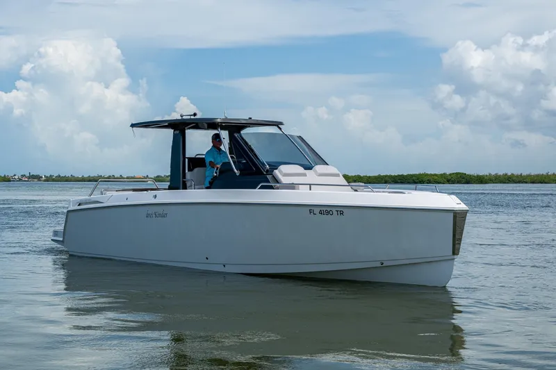 Slide: The Image of 2023 Schaefer V33 boat cruising on calm waters under a cloudy sky. - 39
