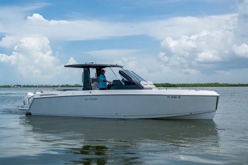 Slide: The Image of 2023 Schaefer V33 boat cruising on calm waters under a partly cloudy sky. - 40