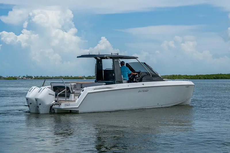 Slide: The Image of 2023 Schaefer V33 boat cruising on calm waters under a cloudy sky. - 41
