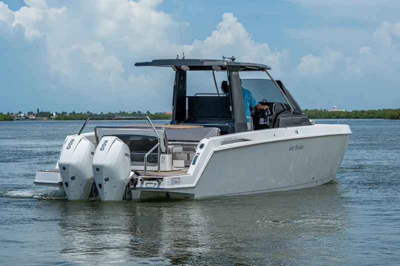 Slide: The Image of 2023 Schaefer V33 boat with dual engines cruising on a calm lake. - 42