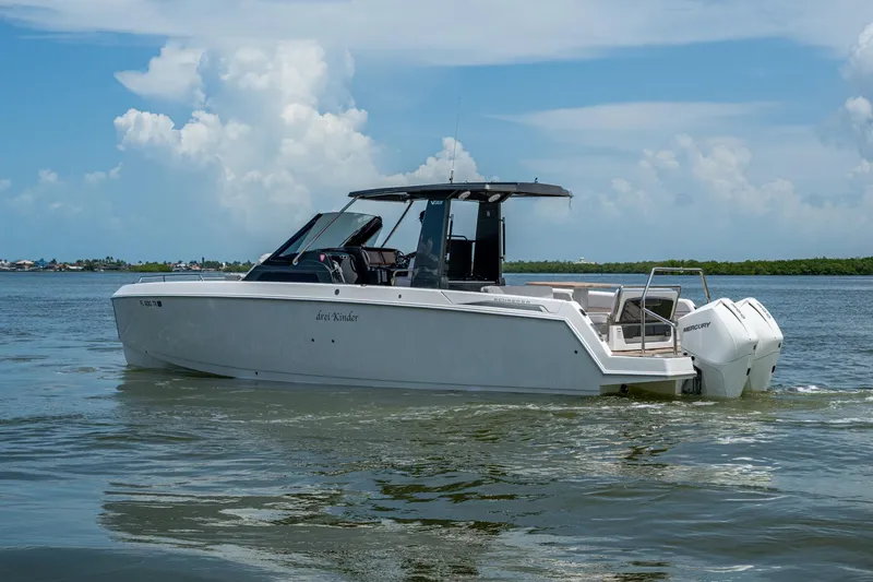 Slide: The Image of 2023 Schaefer V33 boat cruising on calm waters under a clear blue sky. - 43