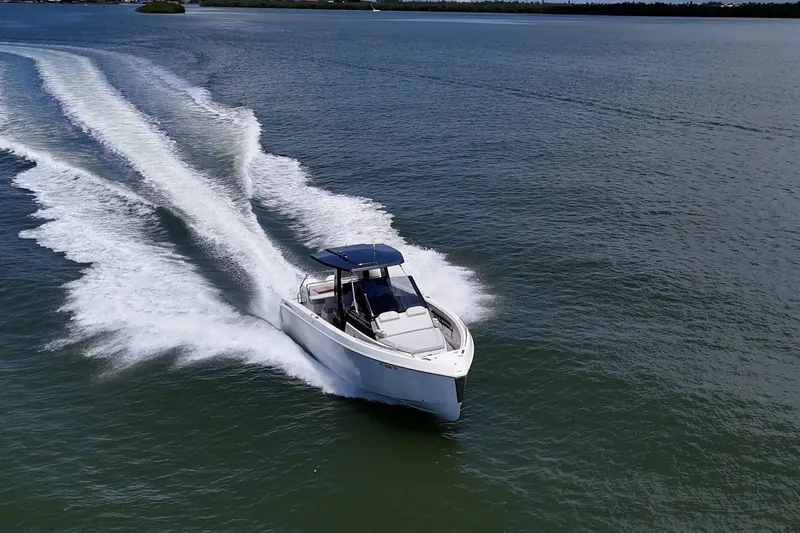 Slide: The Image of 2023 Schaefer V33 boat cruising on open water, creating a dynamic wake. - 45