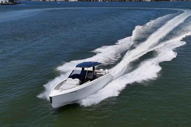 Slide: The Image of 2023 Schaefer V33 boat cruising on open water, leaving a wake behind. - 47