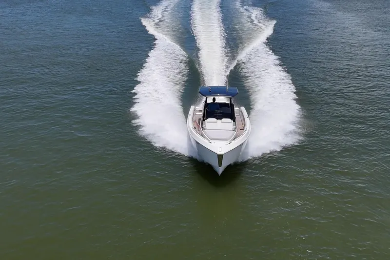 Slide: The Image of 2023 Schaefer V33 boat cruising on open water, creating a dynamic wake. - 48