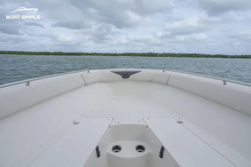 Slide: The Image of 2024 Sailfish 242 CC boat on open water, showcasing spacious bow seating. - 10