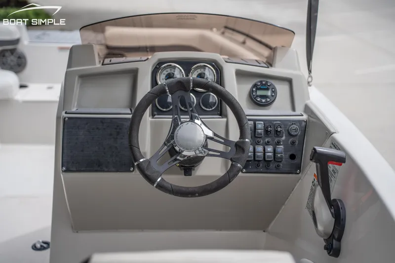 Slide: The Image of 2024 Starcraft SVX 191 OB boat dashboard with steering wheel and control panel. - 12