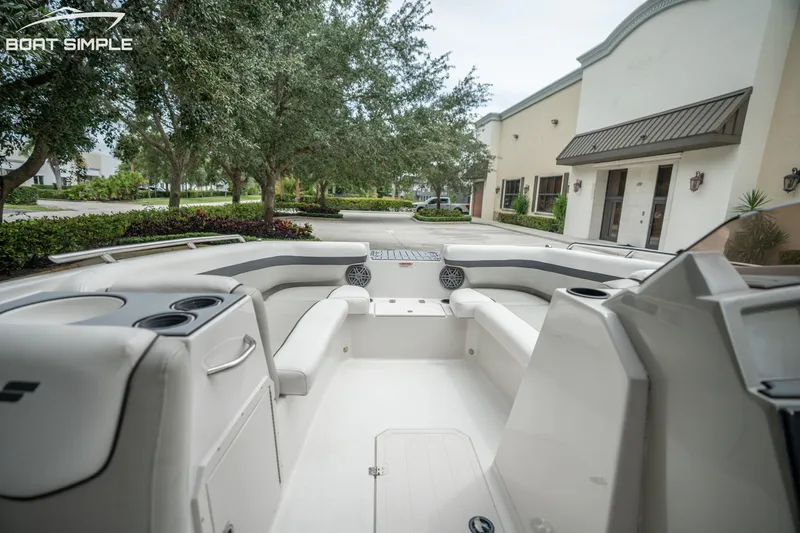 Slide: The Image of 2024 Starcraft SVX 191 OB boat interior with white seating, cup holders, and outdoor setting. - 14