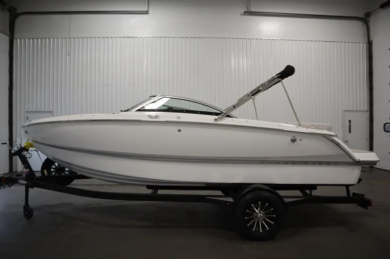 Slide: The Image of 2026 Four Winns H1 Freedom boat on trailer in indoor setting. - 11