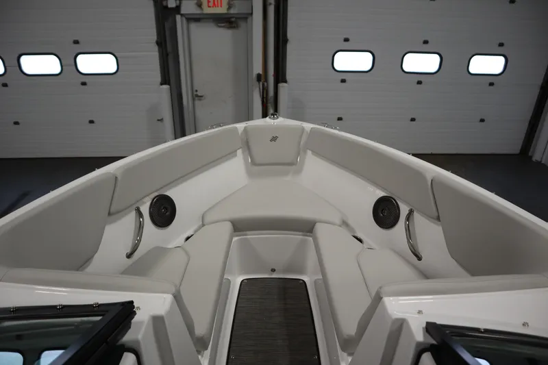 Slide: The Image of 2026 Four Winns H1 Freedom boat interior with cushioned seating and speakers. - 14