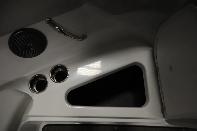 Slide: The Image of Interior detail of 2026 Four Winns H1 Freedom boat, featuring cup holders and storage compartment. - 20