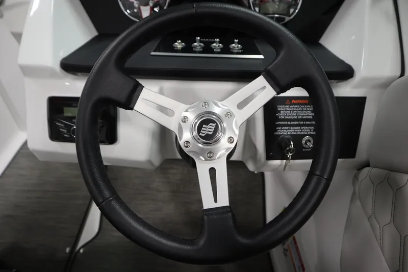 Slide: The Image of Steering wheel of 2026 Four Winns H1 Freedom boat, featuring modern design and controls. - 22