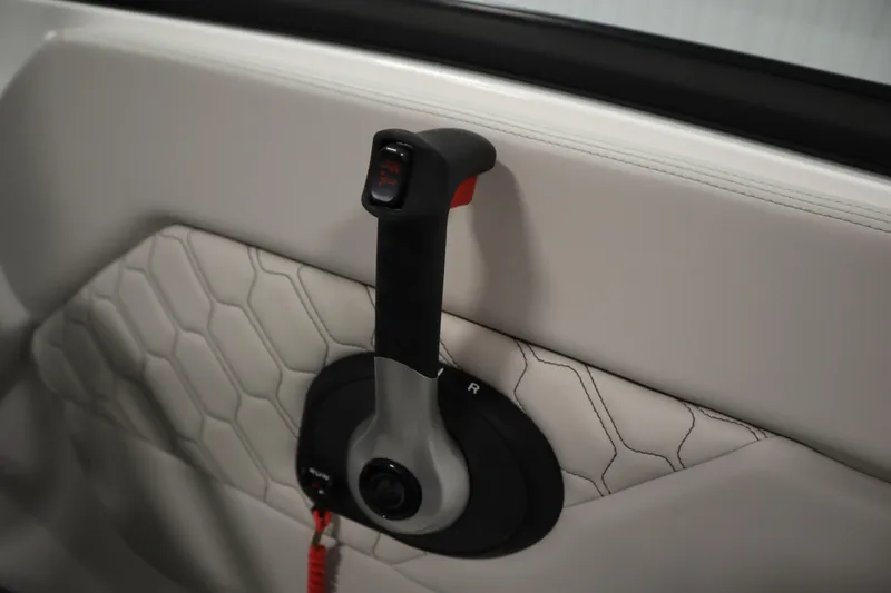 Slide: The Image of 2026 Four Winns H1 Freedom throttle control on quilted interior panel. - 29