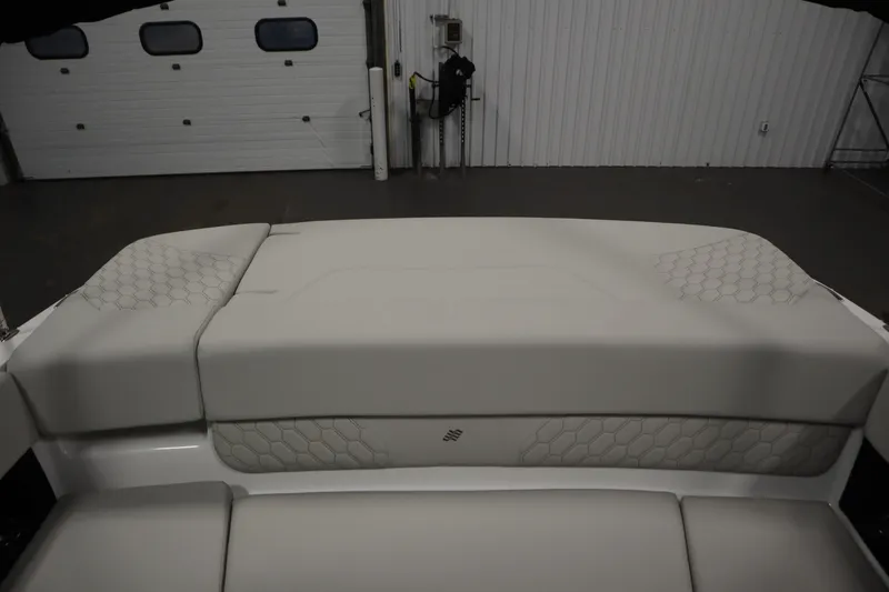 Slide: The Image of 2026 Four Winns H1 Freedom boat interior with cushioned seating and hexagonal pattern design. - 45