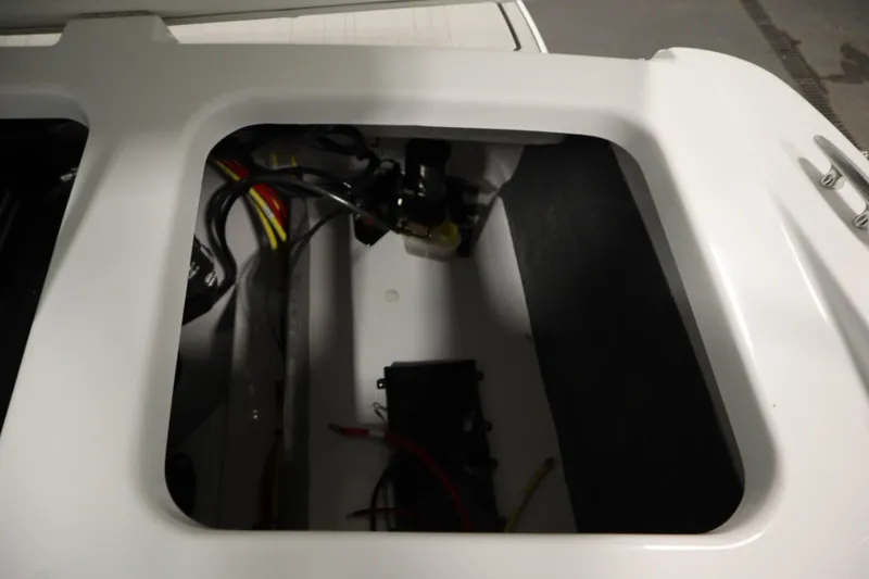 Slide: The Image of 2026 Four Winns H1 Freedom boat compartment with visible wiring and components. - 47