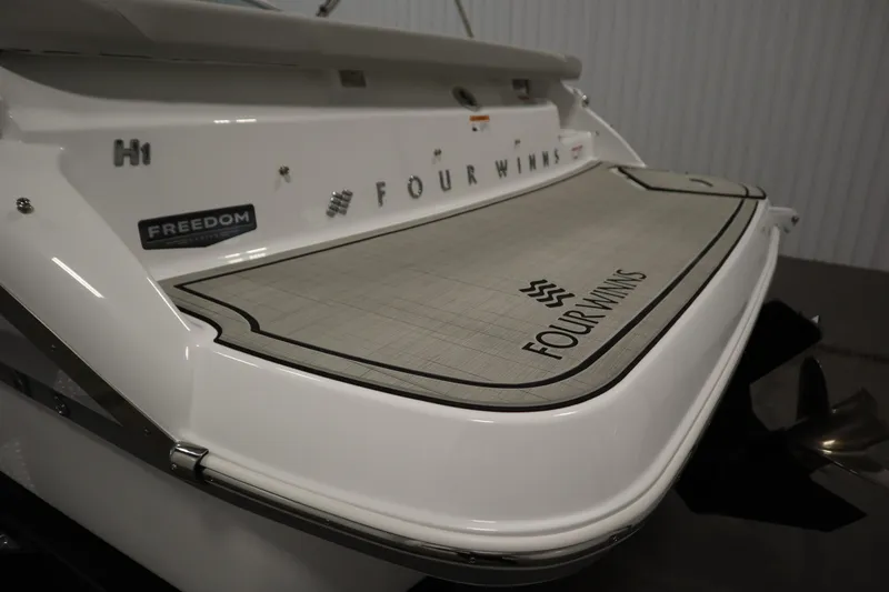 Slide: The Image of 2026 Four Winns H1 Freedom boat stern with branded swim platform. - 52