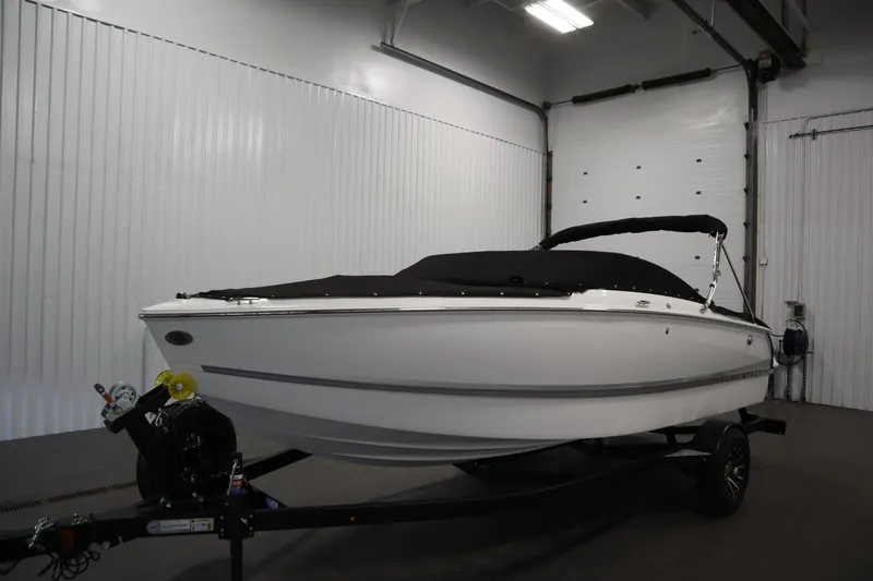 Slide: The Image of 2026 Four Winns H1 Freedom boat in indoor storage, covered and on trailer. - 61