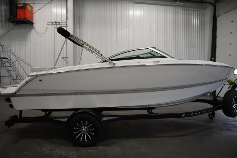 Slide: The Image of 2026 Four Winns H1 Freedom boat on trailer in indoor storage facility. - 7