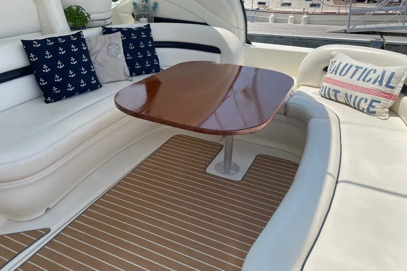 Slide: The Image of Luxurious 2004 Sea Ray 420 Sundancer yacht interior with elegant seating and nautical-themed cushions. - 11
