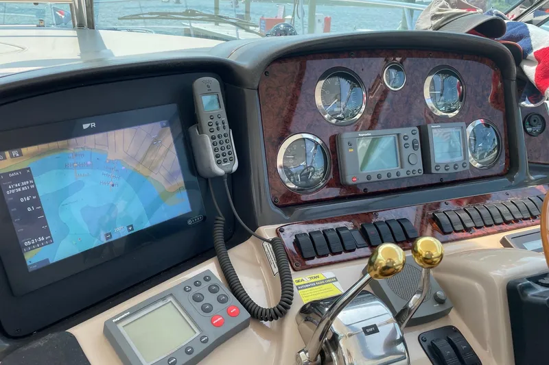 Slide: The Image of Control panel of a 2004 Sea Ray 420 Sundancer with navigation and communication equipment. - 13