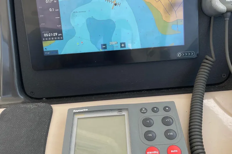 Slide: The Image of Navigation equipment on a 2004 Sea Ray 420 Sundancer boat dashboard. - 14