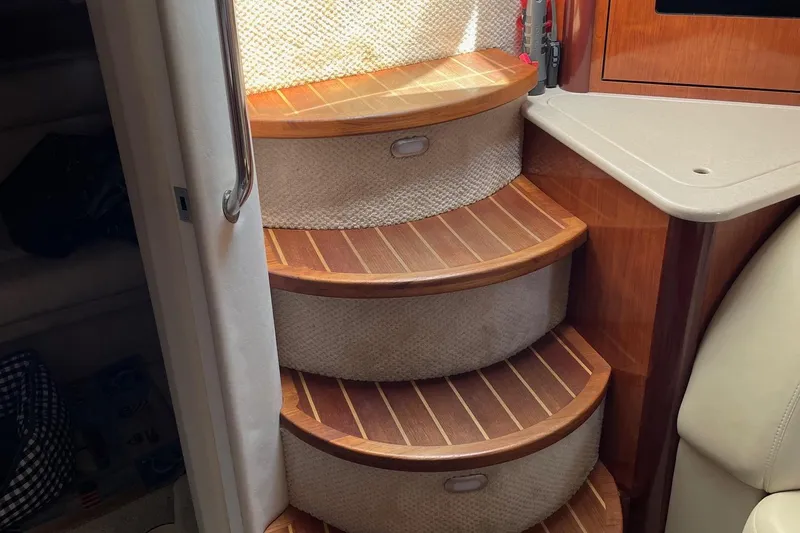 Slide: The Image of Wooden steps inside a 2004 Sea Ray 420 Sundancer yacht, featuring elegant design and craftsmanship. - 15