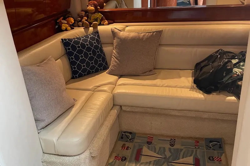 Slide: The Image of Interior of 2004 Sea Ray 420 Sundancer with beige leather seating and decorative pillows. - 16