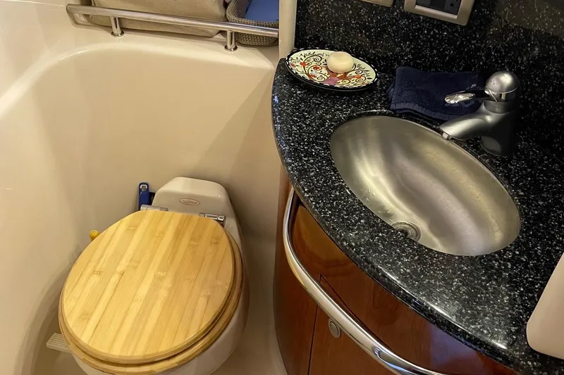 Slide: The Image of Luxury bathroom in 2004 Sea Ray 420 Sundancer yacht with wooden toilet seat and granite sink. - 20