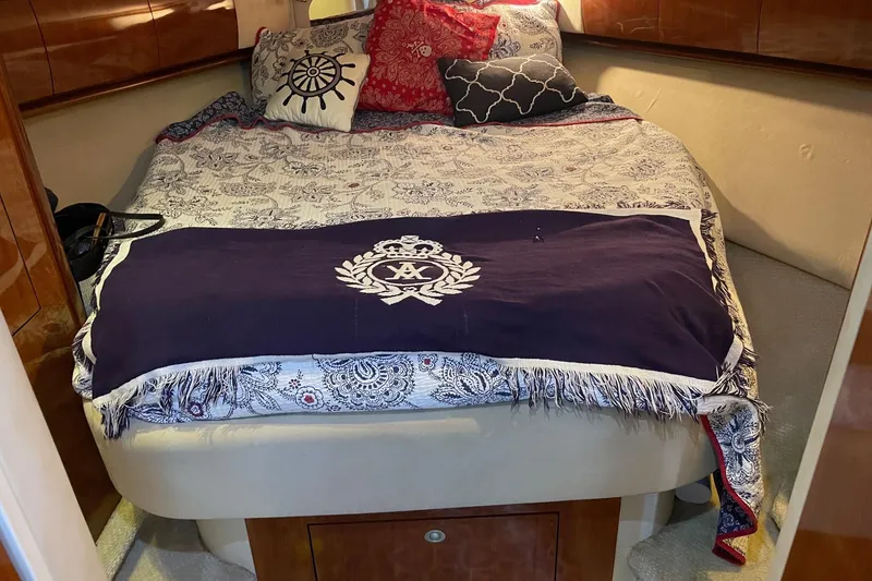 Slide: The Image of Luxurious cabin interior of 2004 Sea Ray 420 Sundancer with elegant bedding and cushions. - 21