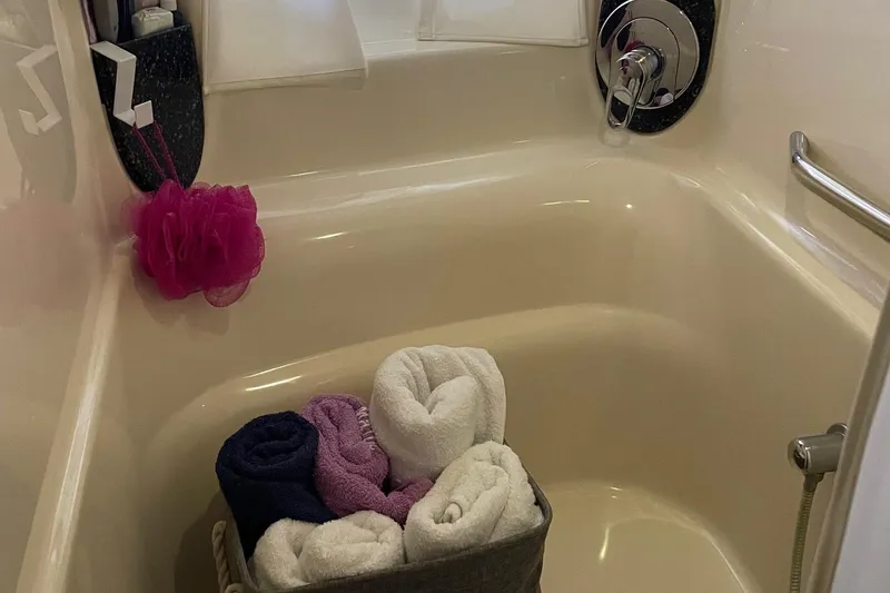 Slide: The Image of Bathroom in 2004 Sea Ray 420 Sundancer with towels and shower accessories. - 22