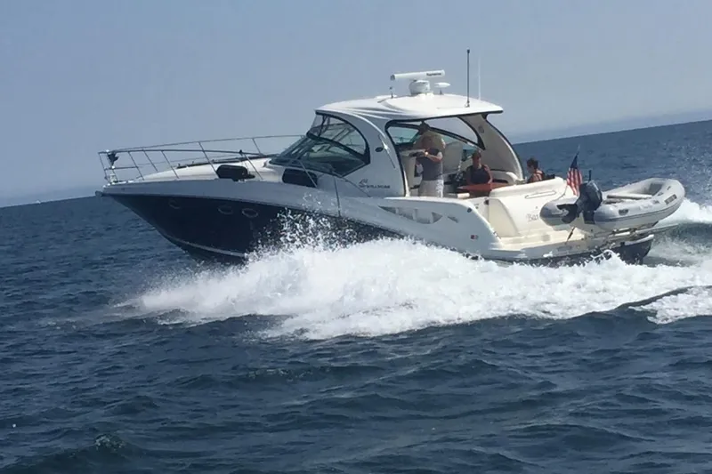 Slide: The Image of 2004 Sea Ray 420 Sundancer cruising on open water with passengers onboard. - 27