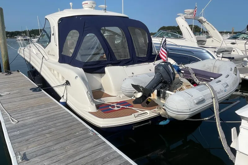 Slide: The Image of 2004 Sea Ray 420 Sundancer yacht docked with inflatable boat and Yamaha motor. - 7