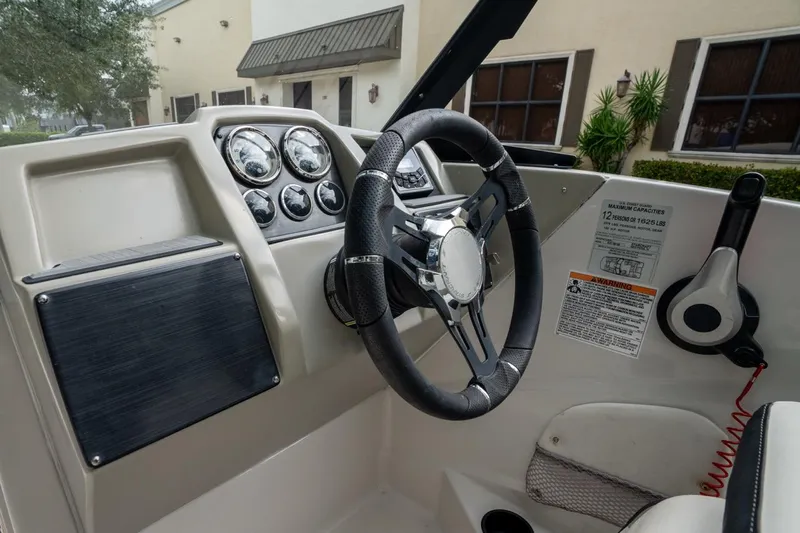 Slide: The Image of 2022 Starcraft SVX 190 DC boat dashboard with steering wheel and gauges. - 11