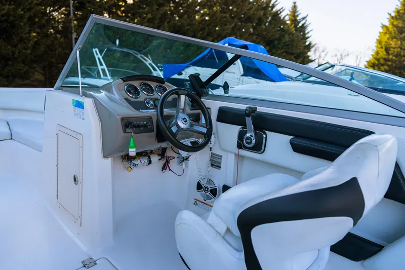 Slide: The Image of 2018 Chaparral 210 Suncoast boat interior with steering wheel and dashboard. - 4