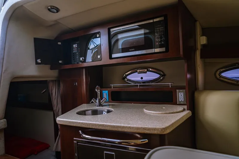 Slide: The Image of 2018 Chaparral 270 Signature cabin interior with kitchenette, microwave, and sink. - 7