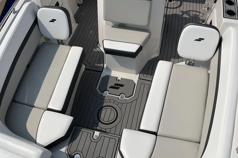 Slide: The Image of 2025 Starcraft SVX 191 OB CC boat interior with cushioned seating and sleek flooring design. - 5