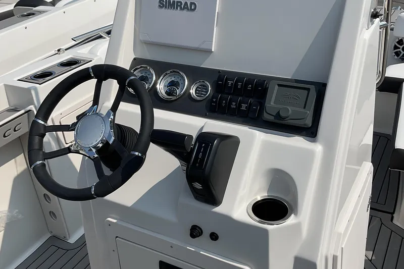 Slide: The Image of 2025 Starcraft SVX 191 OB CC boat dashboard with steering wheel and control panel. - 8