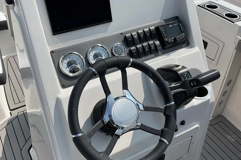 Slide: The Image of 2025 Starcraft SVX 191 OB CC boat dashboard with steering wheel and controls. - 9