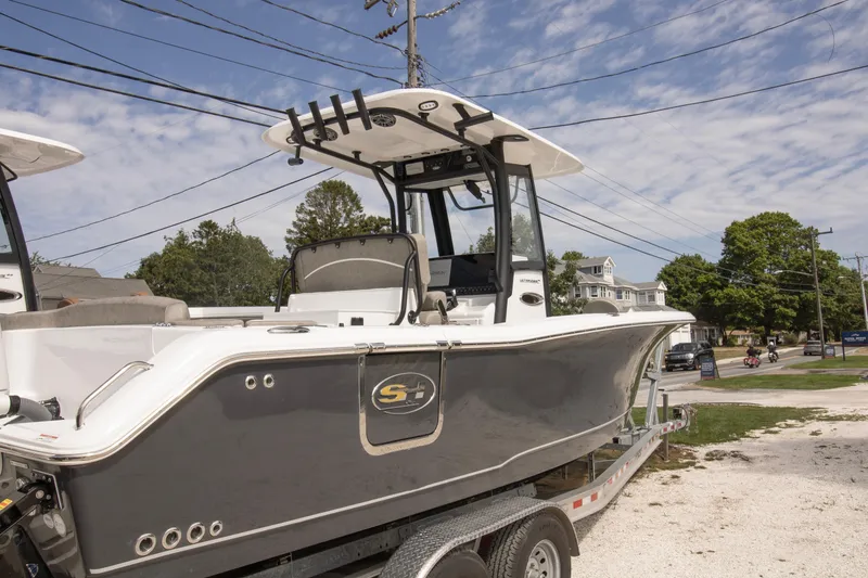 The Image of 2026 Sea Hunt Ultra 265 SE boat on trailer, parked outdoors under a clear sky. - 0