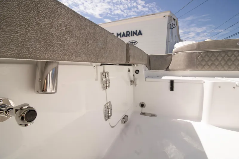 Slide: The Image of 2026 Sea Hunt Ultra 265 SE boat interior with cushioned seating and stainless steel fixtures. - 11