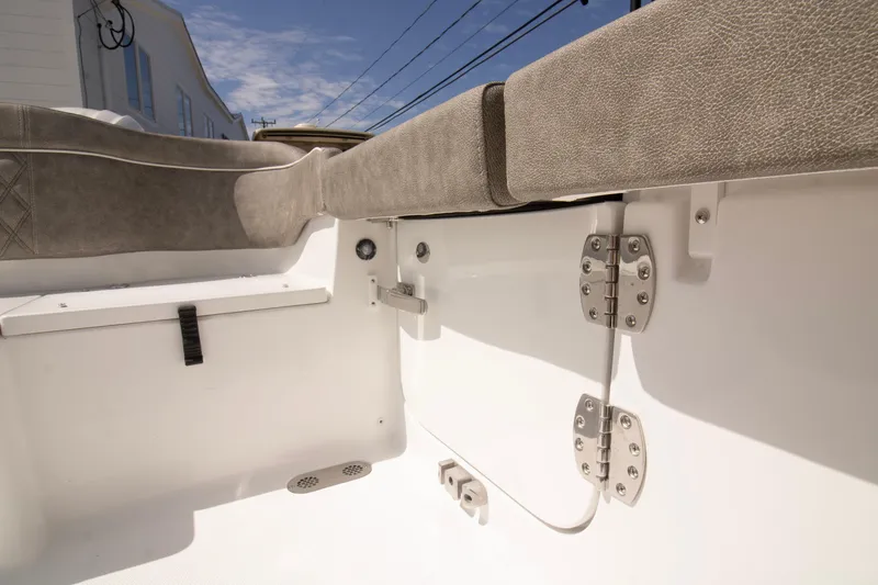 Slide: The Image of Interior view of 2026 Sea Hunt Ultra 265 SE boat, featuring cushioned seating and stainless steel hinges. - 12