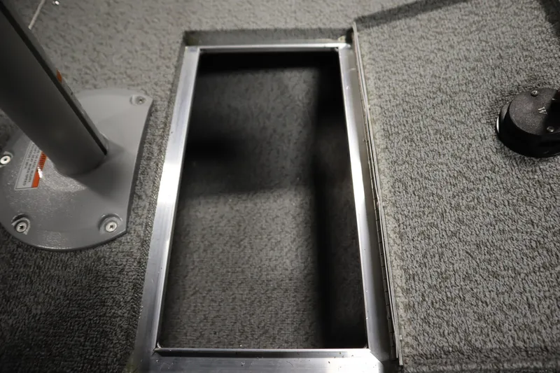 Slide: The Image of Interior view of 2026 Crestliner 2050 Commander boat, featuring a storage compartment. - 12