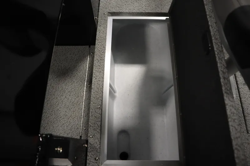 Slide: The Image of 2026 Crestliner 2050 Commander storage compartment with open lid, showcasing interior space. - 13