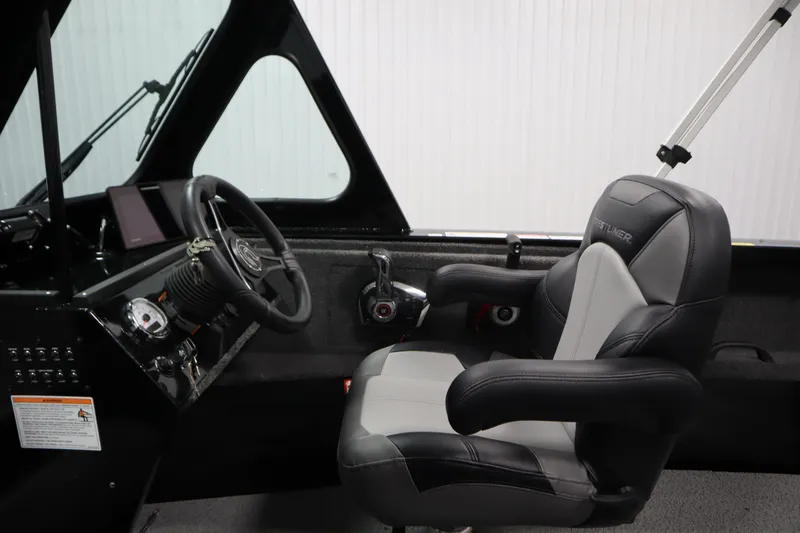 Slide: The Image of 2026 Crestliner 2050 Commander boat interior with steering wheel and captain's chair. - 14