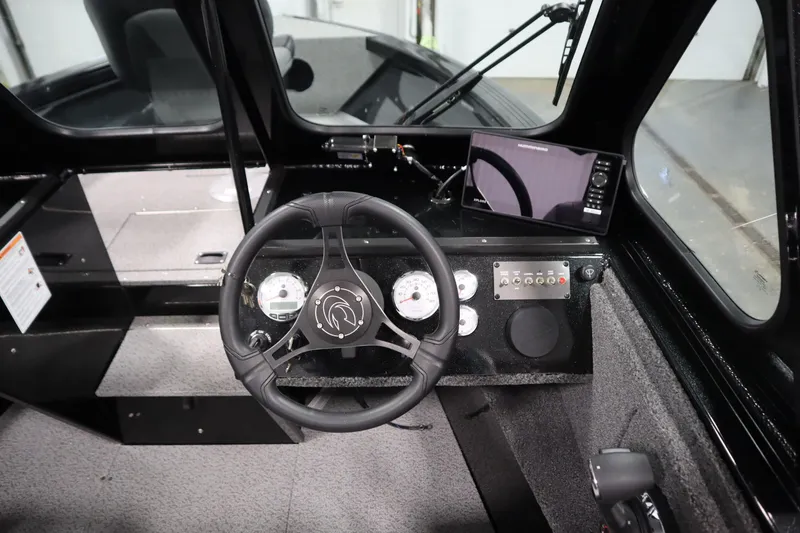 Slide: The Image of Interior view of 2026 Crestliner 2050 Commander boat cockpit with steering wheel and controls. - 15