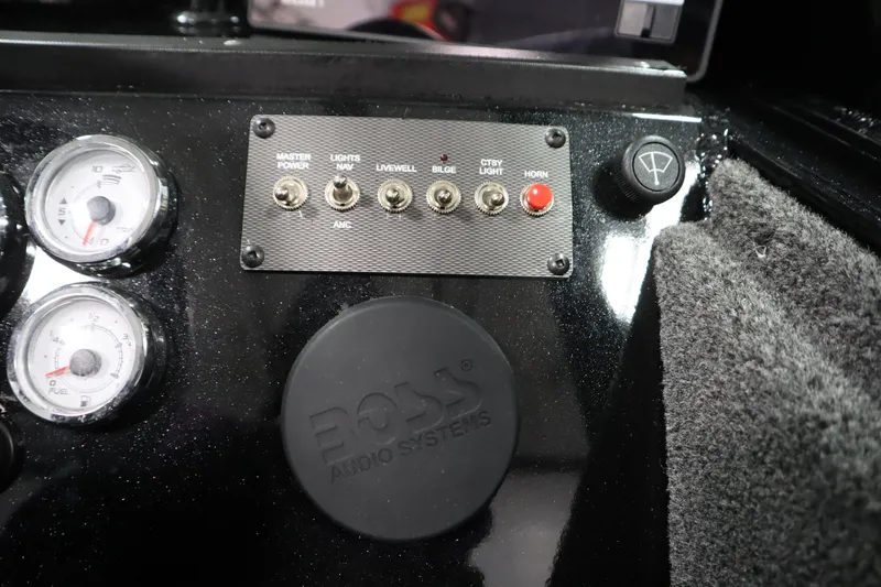 Slide: The Image of Control panel of 2026 Crestliner 2050 Commander with switches and gauges. - 21