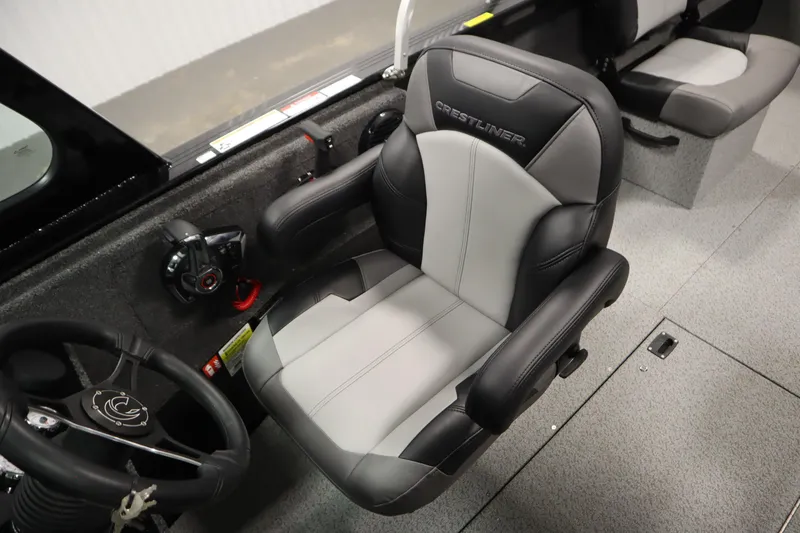 Slide: The Image of 2026 Crestliner 2050 Commander boat interior with steering wheel and cushioned seat. - 22