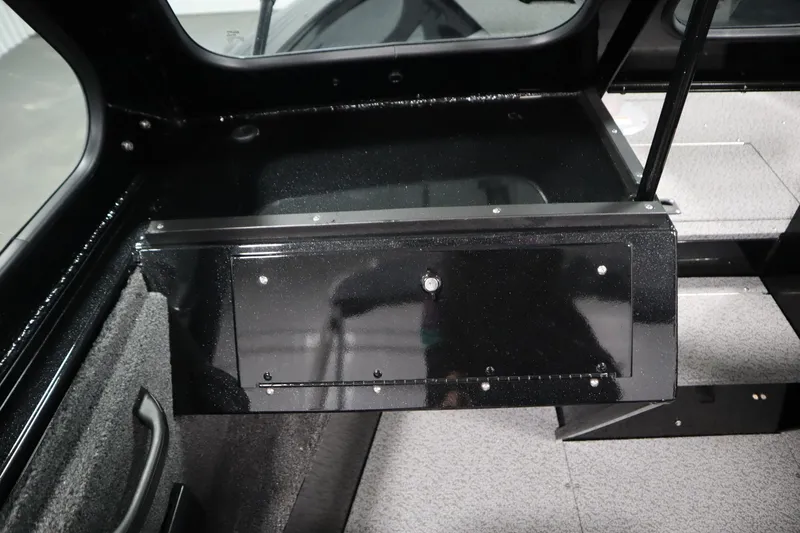Slide: The Image of 2026 Crestliner 2050 Commander interior storage compartment with sleek black finish. - 23