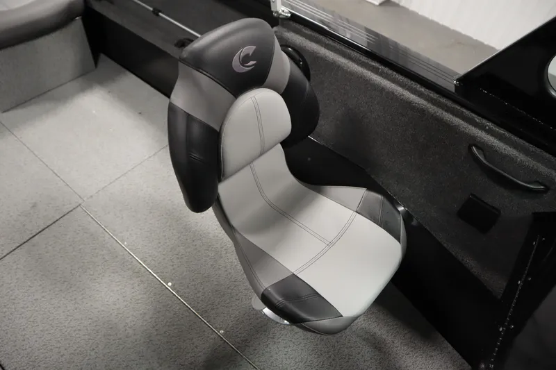 Slide: The Image of 2026 Crestliner 2050 Commander boat seat, gray and black design, interior view. - 25