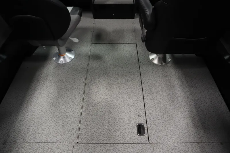 Slide: The Image of Interior view of 2026 Crestliner 2050 Commander boat with gray flooring and two seats. - 26